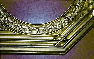 Detail, final condition: restored and gilded leaf ornamentation. 